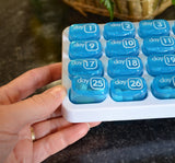 Daily 2x a day pill organizer! 2 sets of 31 Daily pill boxes in a tray organize your pills for the entire month. Each box is numbered - great for senior parents. Take one out and keep in your pocket or purse to take meds later. 